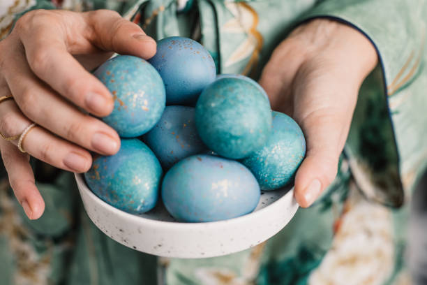 istock Woman holding modern dyed blue easter eggs 655023772