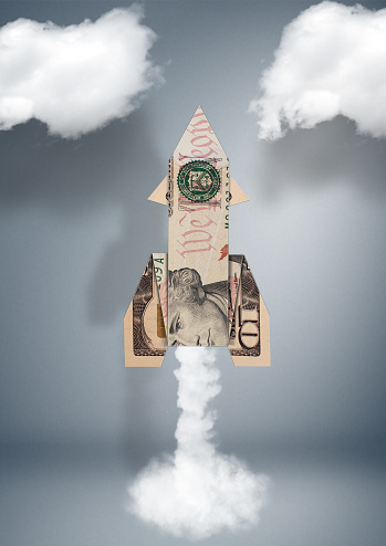Start financial business concept, rocket made of money