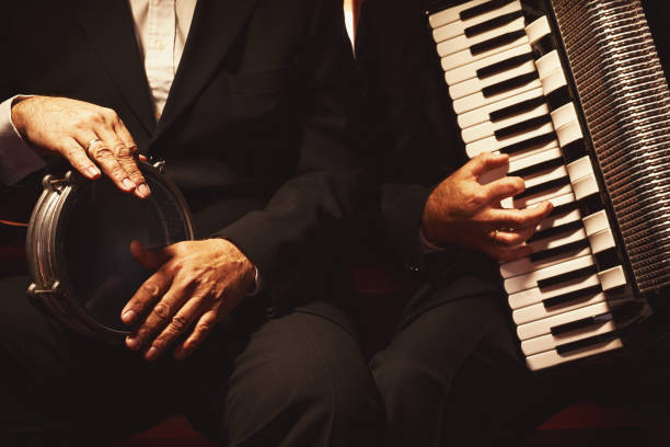 Two Musicians on Their Instruments Hands of percussionist and accordionist with instruments. drummer hands stock pictures, royalty-free photos & images