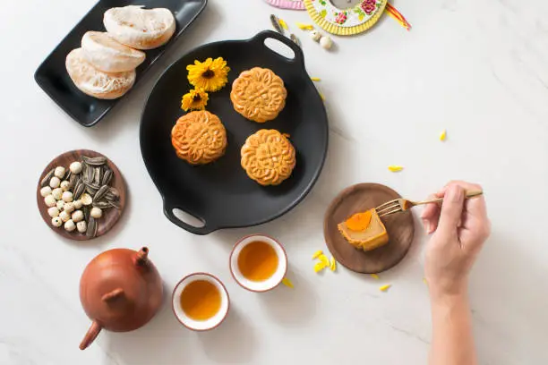 Overhead view mid autumn mooncake and tea set on marble table top background.