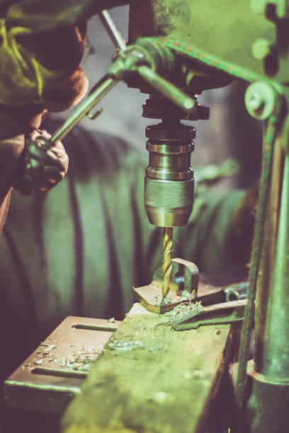 istock Worker drilling holes in a steel part 655053070