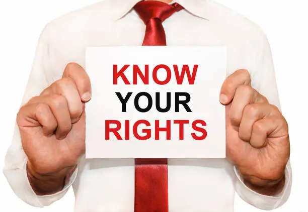 Photo of Man holding a card with a text Know Your Rights