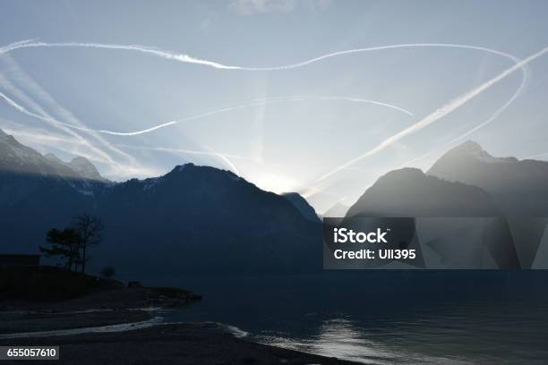 Jetstreams In The Sky Above The Lake At Sundown Nr2 Stock Photo - Download Image Now