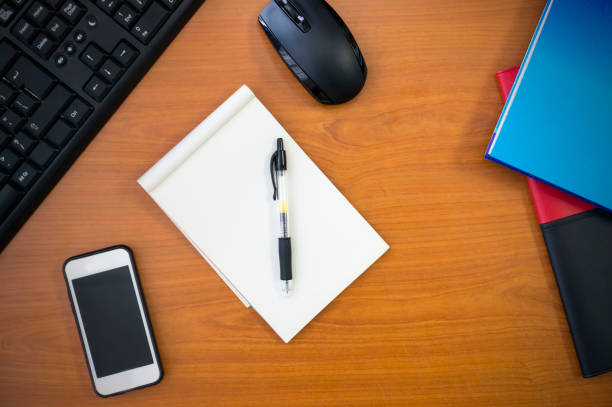 istock wooden work desk top view with copy space. 655060194