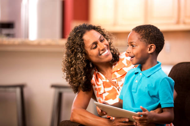 istock Mother reading at home with young son. 655060666