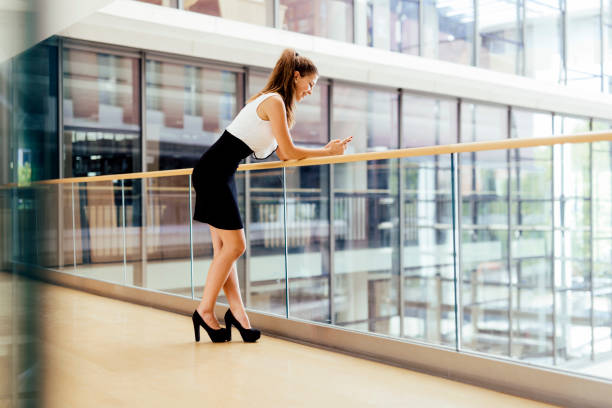 istock Beautiful businesswoman using phone and smiling 655065668