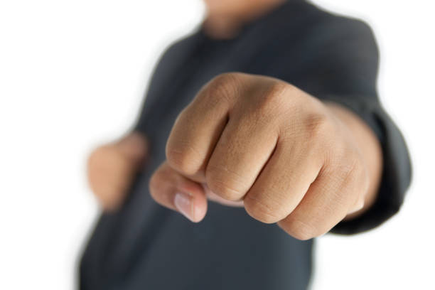istock man with suit fist punching isolated on white 655069092