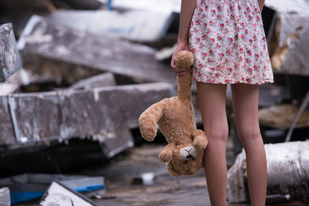 Sad woman standing with doll