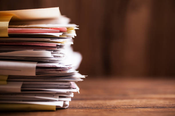 Large stack of paperwork, files on office desk with copyspace. Large stack of files, paperwork on office desk with copyspace.  Overworked concept. bureaucracy stock pictures, royalty-free photos & images