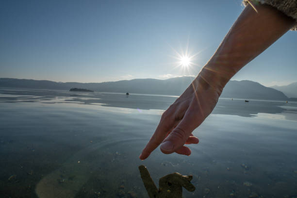 istock Human hand cupped to catch fresh water from lake 655083948