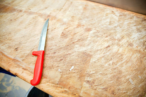 Kitchen knife on wooden cutting board in store