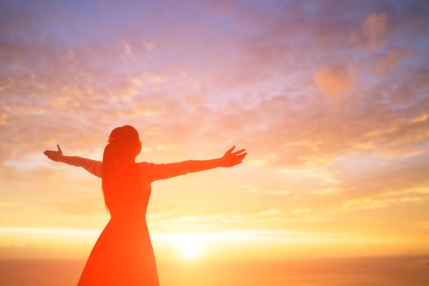woman pray pious young woman pray pious with sunrise, asian female mountain biker silhouette stock pictures, royalty-free photos & images