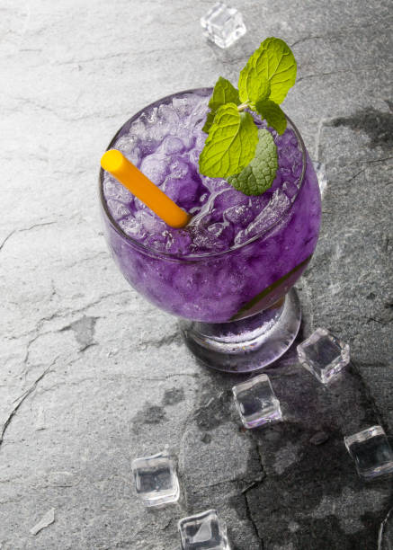 istock Purple soda lime drink with lime on stone. 655088466