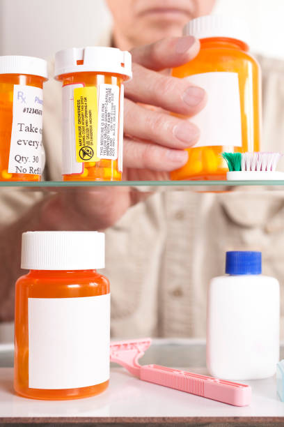 senior hombre adulto obtiene medicamentos de la caja. - medicine cabinet cabinet medicine bathroom fotografías e imágenes de stock