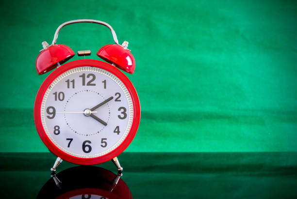 istock Alarm clock close up isolated on green background. 655097816