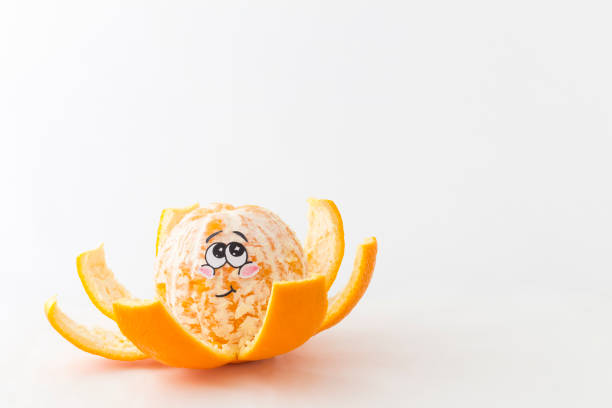 a half peeled tangerine in front of white background with a funny blushing face