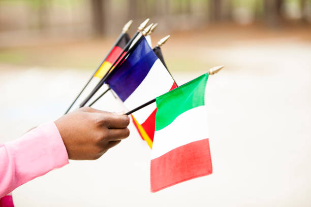 istock African descent woman holding flags from various countries. 655108474