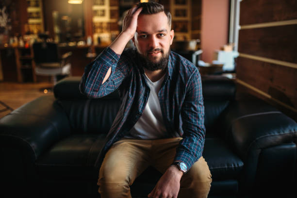 istock Man waiting on a couch at the hairdressing salon 655108522