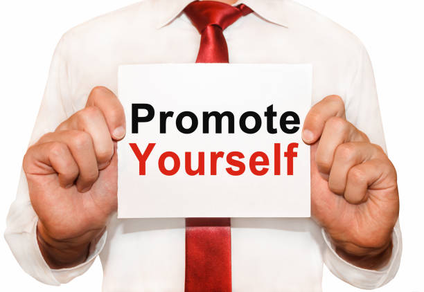 istock Man holding a card with a text Promote Yourself 655108764