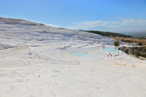 People at Pamukkale travertines. Layers of travertines form terraces of carbonate minerals in Pamukkale, Southwest Turkey. - 09/19/2013