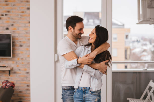 istock Beautiful young couple hugging in their new appartment. 655120518
