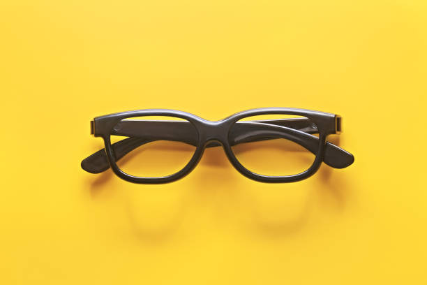 Black glasses on a yellow background
