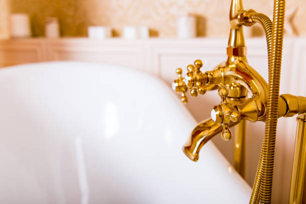 istock Rich gold faucet and white bath in the bathroom 655123386