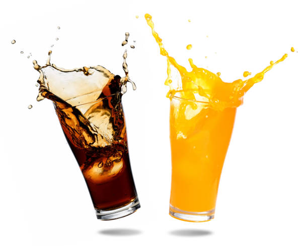 Soft drinks splashing Orange juice and cola splashing out of glass., Isolated white background. cold drink stock pictures, royalty-free photos & images