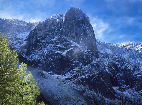 Yosemite Valley winter view of Sentinel Rock with clouds oin background sky

