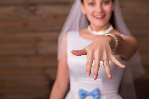 istock Bride showing golden wedding ring on her hand 655126700