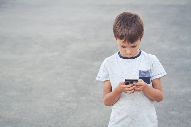 istock Boy with mobile phone. School, people, technology, leisure concept 655134180