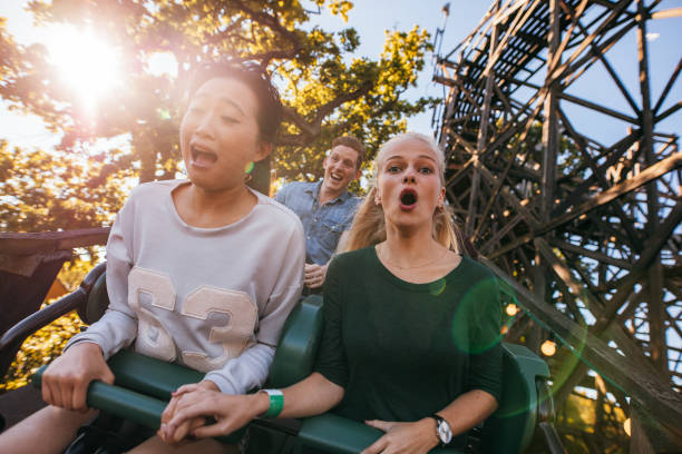 istock People enjoying a ride in amusement park 655134850