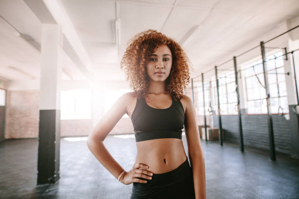 istock Determined african female standing in the gym 655137190