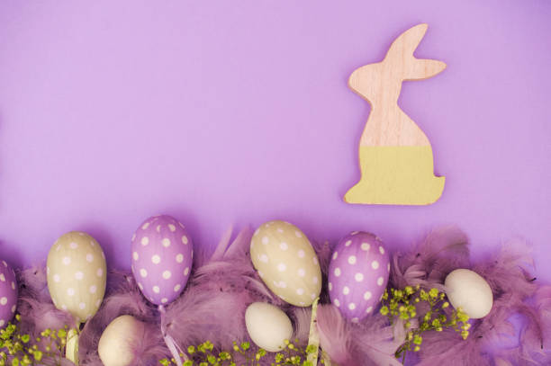 istock Easter Eggs and Wooden Bunny on Purple Background 655140306