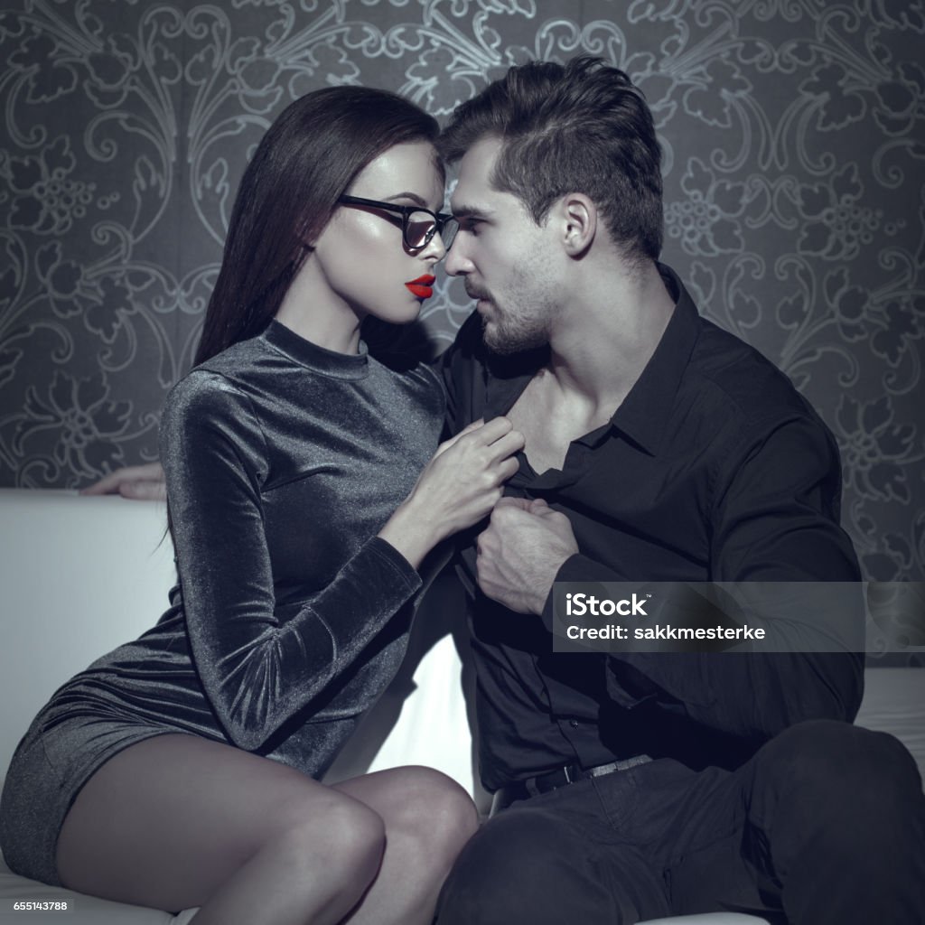 Woman undressing rich man shirt selective coloring Adult Stock Photo