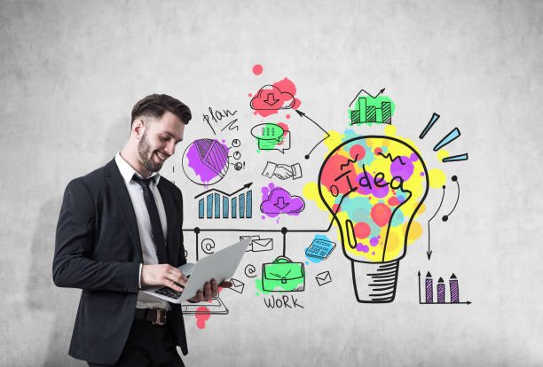 istock Guy with a laptop and bright idea on concrete 655153818