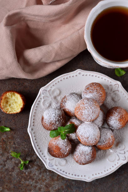 istock Homemade donuts with powdered sugar for breakfast on the old grunge background 655156024