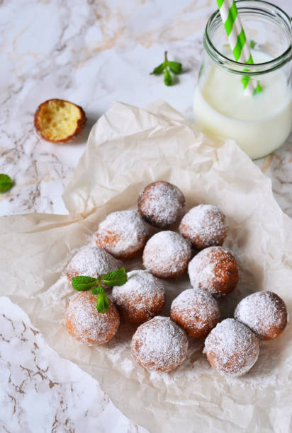 istock Homemade donuts with powdered sugar and milk on a marble background 655156070