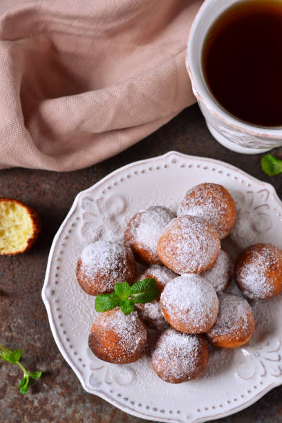 istock Homemade donuts with powdered sugar for breakfast on the old grunge background 655156120