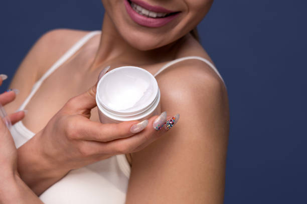 istock young woman holding cosmetic cream 655165080