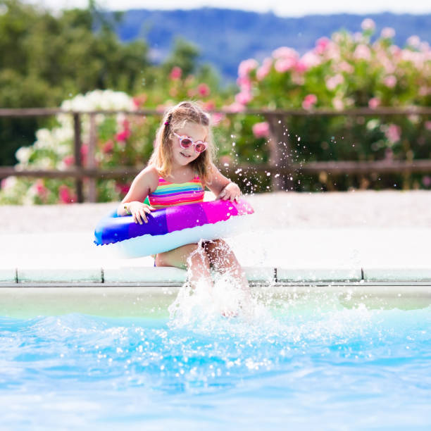 istock Child with toy ring in swimming pool 655165174