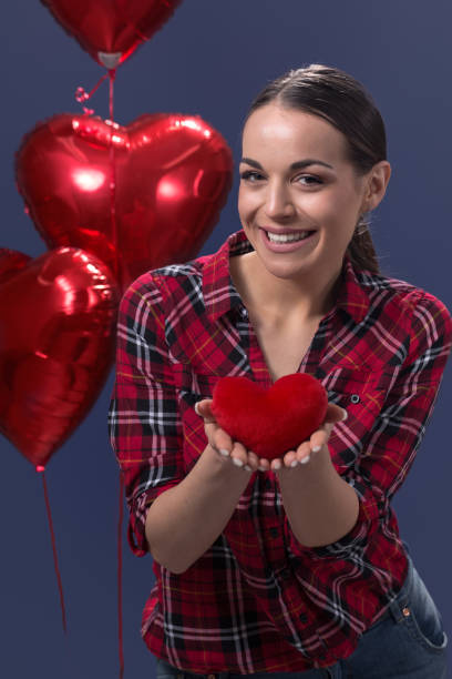 istock Beautiful woman holding red heart 655165412