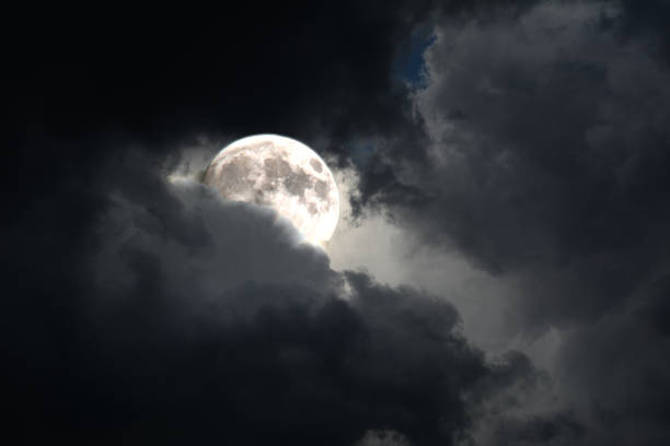 istock full moon surface peeking out of the clouds 655168726