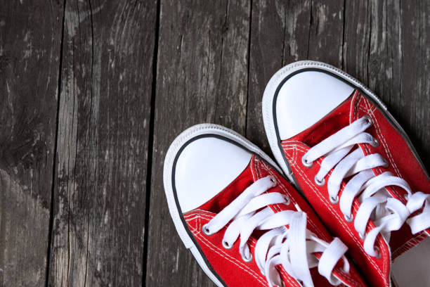 istock red sneakers on wooden background 655179538