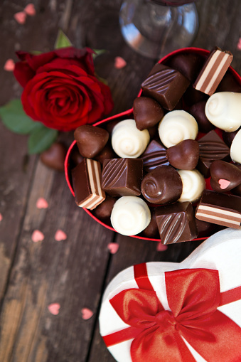 Mother’s Day- Gift box with red roses and chocolates background