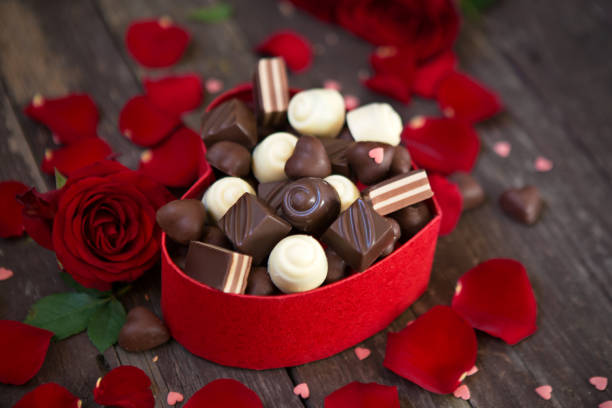 istock Gift box with red roses and chocolates on wooden background 655185718