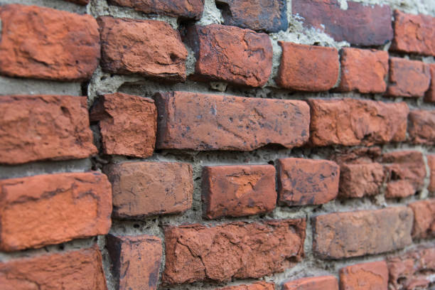 istock Fragment of old brick wall with multicolored bricks and tones, background 655190296
