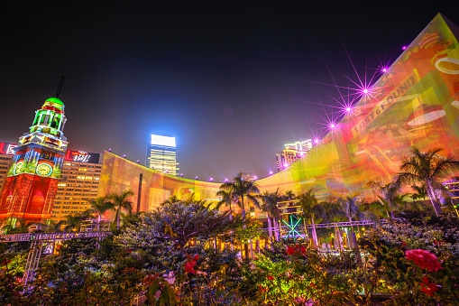 Hong Kong, China - December 5, 2016: 3D light show of Hong Kong Cultural Centre and Clock Tower, popular symbol of Hong Kong city. Victoria Harbour waterfront, Tsim Sha Tsui. Night scene.