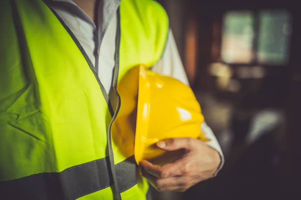 istock Close-up of an engineer holding yellow hardhat 655224210