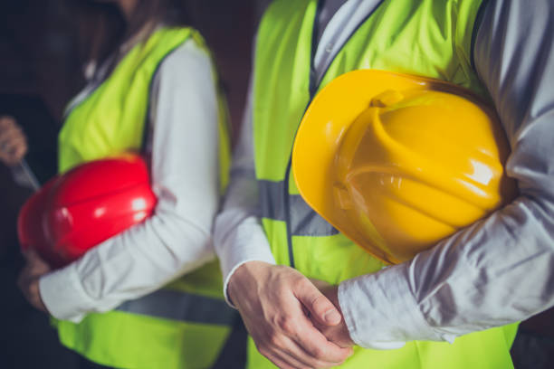 istock Close-up of two engineers holding hardhats on a construction site 655224330
